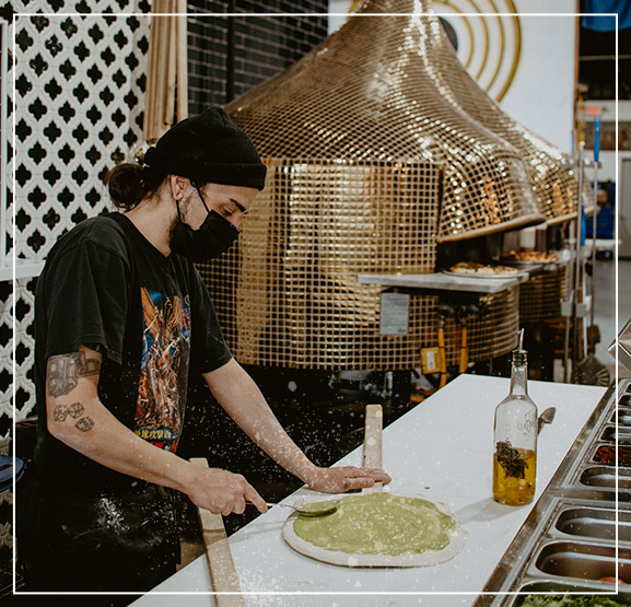 man making pizza